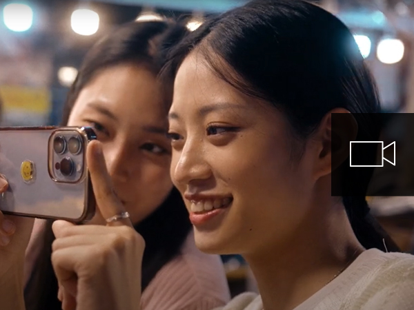 Two girls taking a selfie with their cell phone